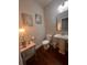 Cozy powder room features pedestal sink, hardwood floors, and decorative wall hangings at 1935 Manor Pointe Dr, Cumming, GA 30041
