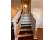 Carpeted staircase features a painted white banister and dark stained steps at 1935 Manor Pointe Dr, Cumming, GA 30041