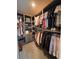 Spacious walk-in closet with custom shelving and ample storage for shoes, folded clothing, and hanging garments at 1935 Manor Pointe Dr, Cumming, GA 30041