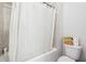 Bathroom featuring a toilet, tiles and a shower with a curtain at 2808 Blandwood Rd, Marietta, GA 30064