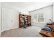 Bedroom with gray carpet, bookshelves, and a large window allowing for natural light at 2808 Blandwood Rd, Marietta, GA 30064
