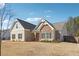 Well-maintained single-Gathering home featuring brick and stone accents, set against a bright blue sky backdrop at 2808 Blandwood Rd, Marietta, GA 30064