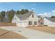 Desirable home showcasing a three-car garage and a blend of brick and stone on its charming facade at 2808 Blandwood Rd, Marietta, GA 30064