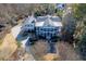 Aerial view of grand two-story home with a circular drive and mature trees at 3980 Saint Elisabeth Sq, Duluth, GA 30096
