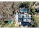 Stunning aerial view of estate with pool, tennis court and mature trees at 3980 Saint Elisabeth Sq, Duluth, GA 30096