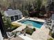 A high angle view of the backyard featuring a pool, pool house, garden, and patio of a luxury residence at 3980 Saint Elisabeth Sq, Duluth, GA 30096