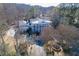 Expansive aerial view of a grand home featuring a circular driveway, mature trees and lush landscaping at 3980 Saint Elisabeth Sq, Duluth, GA 30096