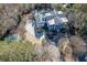 An aerial view showcases the property's pool, lush greenery, and large circular driveway at 3980 Saint Elisabeth Sq, Duluth, GA 30096