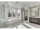 This bathroom boasts a walk-in shower, tub under bay windows and double vanity sinks with beautiful natural light at 3980 Saint Elisabeth Sq, Duluth, GA 30096