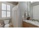 Stylish bathroom features neutral textured walls, shuttered window, granite countertop and modern fixtures at 3980 Saint Elisabeth Sq, Duluth, GA 30096