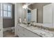 Bathroom features a double vanity with granite counters, decorative mirrors and a tiled floor at 3980 Saint Elisabeth Sq, Duluth, GA 30096