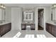 This bathroom features double vanity sinks, a makeup vanity, and a door leading to a walk-in closet at 3980 Saint Elisabeth Sq, Duluth, GA 30096