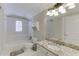 Bathroom with a shower-tub combo, and a white vanity with granite counters and ample storage space at 3980 Saint Elisabeth Sq, Duluth, GA 30096