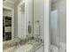 Bright bathroom features white cabinetry, granite countertop, modern fixtures, and a walk-in closet at 3980 Saint Elisabeth Sq, Duluth, GA 30096