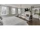 Bright bedroom boasting a fireplace, built-in shelving, and three large windows at 3980 Saint Elisabeth Sq, Duluth, GA 30096