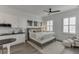 A modern bedroom includes a kitchenette, sleek ceiling fan, and ample natural light enhancing the contemporary design at 3980 Saint Elisabeth Sq, Duluth, GA 30096