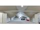Spacious bonus room with high ceilings featuring an exercise bike, built in shelving and storage spaces at 3980 Saint Elisabeth Sq, Duluth, GA 30096