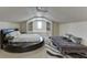 Large bonus room with high ceilings featuring two beds, a window seat, and built in shelving for storage at 3980 Saint Elisabeth Sq, Duluth, GA 30096