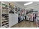 This walk-in closet has custom shelving and drawers, and hanging rods for ample clothing storage at 3980 Saint Elisabeth Sq, Duluth, GA 30096