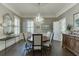 Elegant dining room with chandelier, wainscoting and designer details at 3980 Saint Elisabeth Sq, Duluth, GA 30096