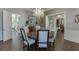 Dining room featuring chandelier, round table and access to other rooms at 3980 Saint Elisabeth Sq, Duluth, GA 30096
