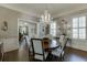 Open dining area features a grand chandelier, hardwood floors and natural lighting at 3980 Saint Elisabeth Sq, Duluth, GA 30096