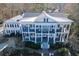 Stately two-story home with a large front porch and white columns, surrounded by trees and landscaping at 3980 Saint Elisabeth Sq, Duluth, GA 30096