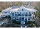 Stately two-story home boasting a white exterior, columned porches and manicured landscaping at 3980 Saint Elisabeth Sq, Duluth, GA 30096