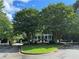 Estate home surrounded by tall, mature trees offering privacy and curb appeal with circle drive and fountain at 3980 Saint Elisabeth Sq, Duluth, GA 30096