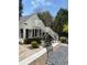 A home's exterior featuring a staircase, black shutters, beautiful landscaping, a brick patio and outdoor dining set at 3980 Saint Elisabeth Sq, Duluth, GA 30096
