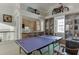 Open game room featuring a ping pong table, wet bar, vaulted ceilings, and decor at 3980 Saint Elisabeth Sq, Duluth, GA 30096