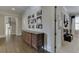 Hallway with hardwood floors, antique sideboard, Gathering photos, and doorways to adjacent rooms at 3980 Saint Elisabeth Sq, Duluth, GA 30096