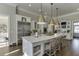 Modern kitchen features marble countertop island with seating, stainless steel appliances, and ample cabinets at 3980 Saint Elisabeth Sq, Duluth, GA 30096