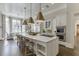 Open kitchen with a large island, white cabinets, pendant lights, and an eat-in nook at 3980 Saint Elisabeth Sq, Duluth, GA 30096