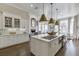 Spacious kitchen featuring a marble island with seating, stainless steel appliances, and pendant lighting at 3980 Saint Elisabeth Sq, Duluth, GA 30096