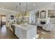 Open concept kitchen and living room features a fireplace and ample seating at 3980 Saint Elisabeth Sq, Duluth, GA 30096