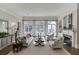 Bright living room boasts a fireplace, neutral furniture, and large windows offering natural light at 3980 Saint Elisabeth Sq, Duluth, GA 30096