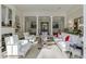 Elegant living room with fireplace, white sofas and chairs, and detailed trim at 3980 Saint Elisabeth Sq, Duluth, GA 30096