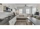 An elegant living space featuring a kitchenette, bed, and contemporary furnishings bathed in natural light at 3980 Saint Elisabeth Sq, Duluth, GA 30096