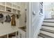 Mudroom boasts coat hooks, storage cubbies, and a sink, leading to a staircase with white trim at 3980 Saint Elisabeth Sq, Duluth, GA 30096