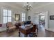 Bright home office with hardwood floors, classic chandelier, and natural light at 3980 Saint Elisabeth Sq, Duluth, GA 30096