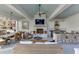 Stylish outdoor living area with a full kitchen, comfortable seating, and a cozy fireplace at 3980 Saint Elisabeth Sq, Duluth, GA 30096