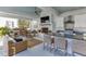 Elegant outdoor living space with a covered patio, outdoor kitchen, fireplace, and wicker furniture at 3980 Saint Elisabeth Sq, Duluth, GA 30096