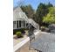 Inviting patio space with outdoor dining, complemented by a view of the manicured garden and stylish home exterior at 3980 Saint Elisabeth Sq, Duluth, GA 30096