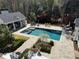 Stunning backyard oasis featuring a pool, spa, and outdoor kitchen perfect for entertaining and relaxing at 3980 Saint Elisabeth Sq, Duluth, GA 30096