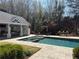 Beautiful pool and spa with an outdoor kitchen area, offering the ultimate in relaxation and entertainment at 3980 Saint Elisabeth Sq, Duluth, GA 30096