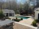 Inviting backyard with pool, outdoor kitchen, and dining area, ideal for outdoor gatherings and summer fun at 3980 Saint Elisabeth Sq, Duluth, GA 30096