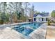 Backyard featuring a sparkling pool with an attached pool house, perfect for outdoor relaxation and enjoyment at 3980 Saint Elisabeth Sq, Duluth, GA 30096