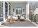Charming porch with wicker chairs, throw pillows, and brick flooring that offers a relaxing outdoor seating area at 3980 Saint Elisabeth Sq, Duluth, GA 30096