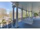 Expansive porch with swing benches, decorative columns, and scenic views at 3980 Saint Elisabeth Sq, Duluth, GA 30096